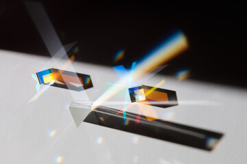 Glass geometric figures prisms with light diffraction of spectrum colors and complex reflection...