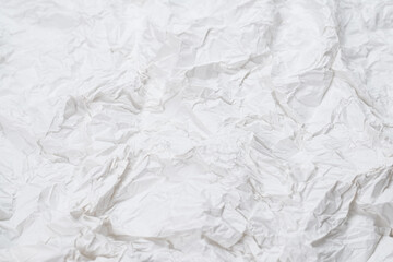Crumpled white paper background.