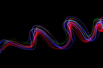 Long exposure photograph of neon multi colour in an abstract swirl, parallel lines pattern against...