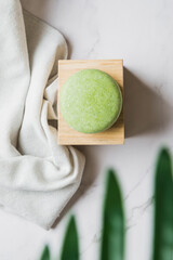 Handmade solid shampoo bar over marble. Zero waste. Top view.