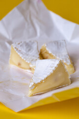 camembert cheese with honey on white paper