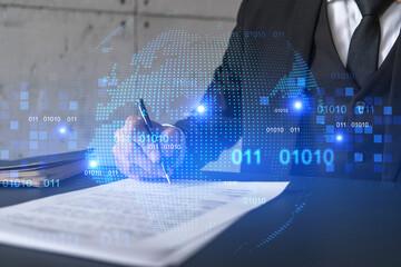 Businessman in suit signs contract. Double exposure with world map hologram. Man signing agreement international business concept.