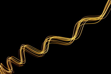 Long exposure photograph of neon gold colour in an abstract swirl, parallel lines pattern against a...