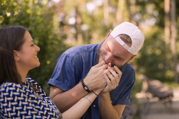 Man is kissing girl tenderly in hand. Holding hands.