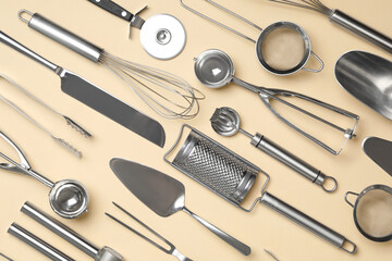 Set of modern cooking utensils on beige background, flat lay