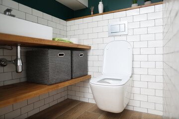 Toilet bowl, sink, shelves with boxes for storing things in toilet. Plumbing installation, repair...