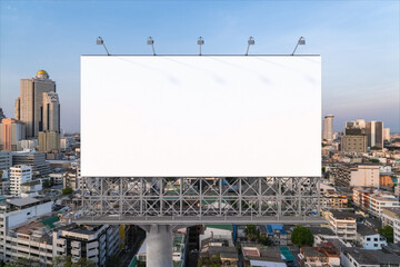 Blank white road billboard with Bangkok cityscape background at sunset. Street advertising poster, mock up, 3D rendering. Front view. The concept of marketing communication to promote or sell idea.