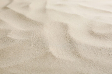 Naklejka na ściany i meble Dry beach sand as background, closeup view