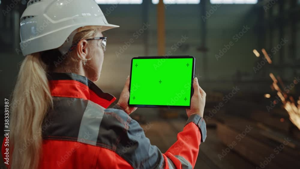 Aufkleber professional heavy industry engineer uses tablet computer with green screen mock up display. female 