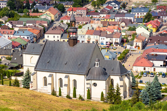 Panoramic view of town Checiny in Swietokrzyskie Mountains, with St. Bartholomew Church at slope of Royal Castle medieval fortress near Kielce in Poland