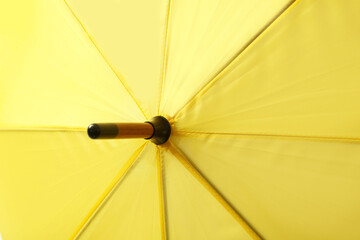 Bright yellow umbrella as background, closeup view
