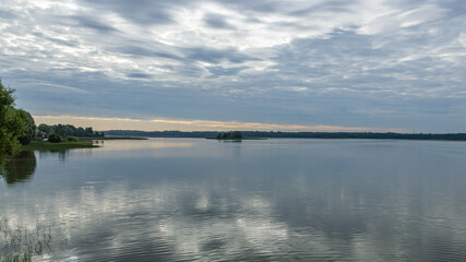 Morning reflection on the lake in the city of Bologoe