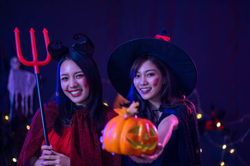 young Asian woman wearing costume in Halloween festival party