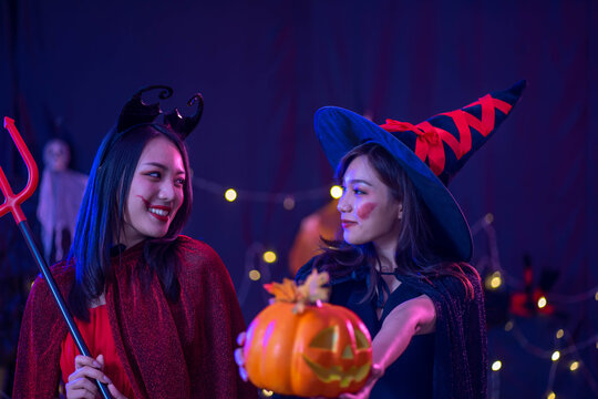 young Asian woman wearing costume in Halloween festival party