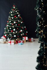 Christmas tree pine black interior room new year decor garland gifts postcard