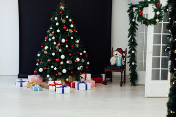 Christmas tree pine black interior room new year decor garland gifts postcard