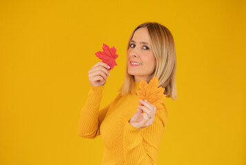 autumn woman in studio over yellow background