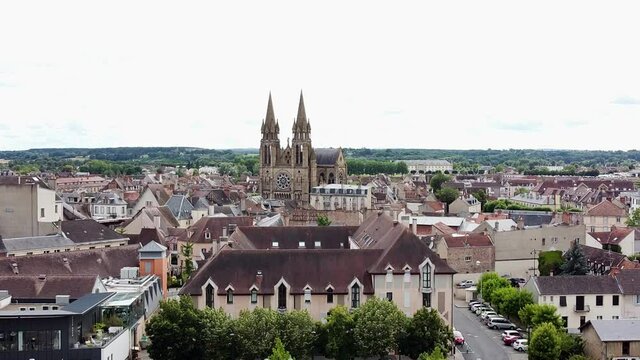 Drone shots of old town moulins lift-off with a church in the back