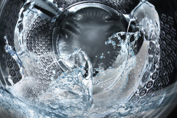 Washing machine drum with water, closeup view - obrazy, fototapety, plakaty