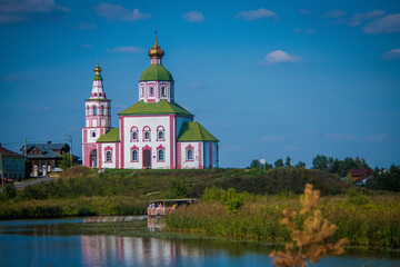 Fototapeta na wymiar Elijah's Church (Cathedral) in the town of Suzdal, Russia. Church on the river Bank against the blue sky. Golden ring of Russia tourist route
