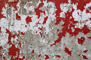 The texture of an old concrete wall with peeling paint. Background for design