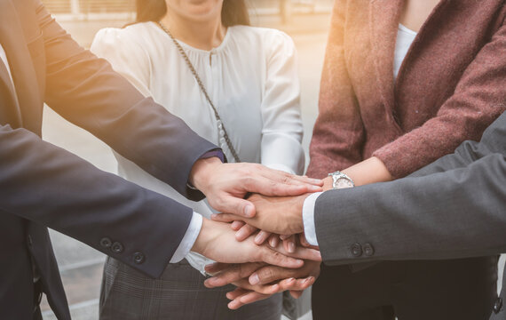 Business people shaking hands, putting their hands together, finishing up meeting. Deal Successful