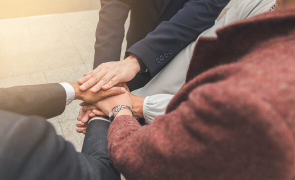 Business people shaking hands, putting their hands together, finishing up meeting. Deal Successful