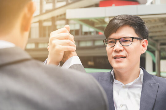 Businessman shaking hands and hold hands finishing meeting or deal successful