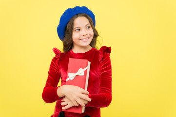 happy kid hold present box on her birthday holiday celebration, childhood happiness