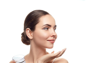 Beautiful Woman holdinging  moisturizing cream . Cosmetics. Portrait of female with clean  skin....