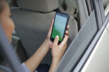 person using a phone in car