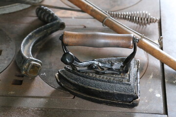 Vintage iron for clothing made of cast iron and wood.
