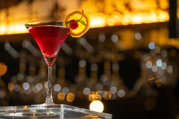 Soft focus and Closeup glass of cosmopolitan cocktail decorated with on the table at bar background.