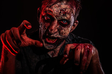 Scary zombie on dark background. Halloween monster