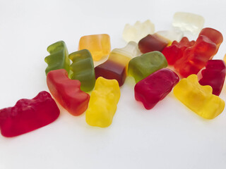 gummy candy on a white matte background. marmalade in the form of gelatinous bears lies on the table. voluminous, non-uniform sweets for dessert made from natural fruits and nectars