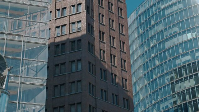 Berlin City Skyline: Close view of the Skyscrapers at Potsdamer Platz in the central business district of germanys capital city. High modern glass buildings of commercial offices rising into the sky.