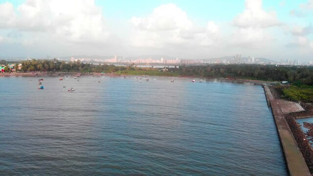 gorai beach dock and cost fishing boat waves on sun set dron shot birds panorama view