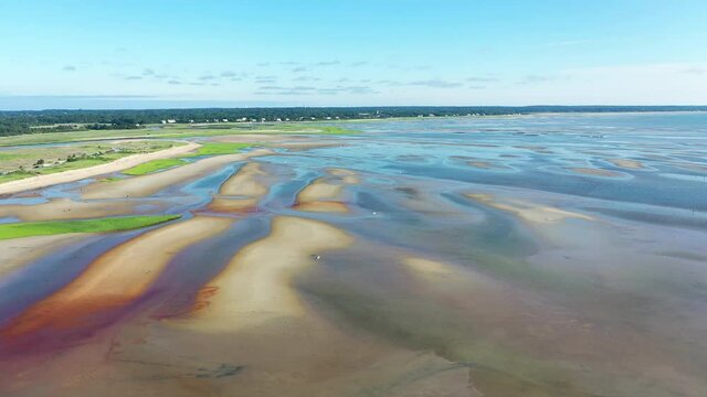 Cape Cod Bay Aerial Drone Footage of Bay Side Beach at Low Tide with Sand Dunes and People Walking in Ocean