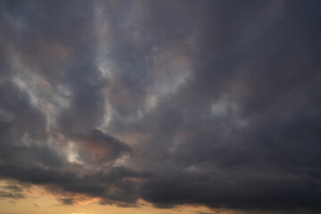 Naklejka na ściany i meble Sky dark with clouds before sunset.