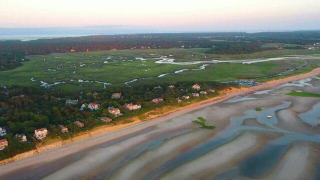 Cape Cod Bay Aerial Drone Footage of Beach Front Houses and Marsh at Low Tide During Golden Hour