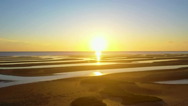 Cape Cod Bay Beach at Low Tide During Golden Hour, Bright Sun Low and Setting, Pan Right