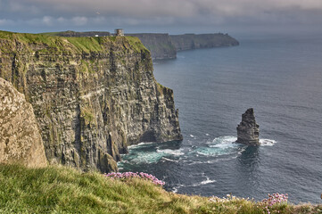 Panoramic view of the Cliffs of Moher, Ireland. Cliffs of Moher during sunset. Coastline in Ireland with huge cliffs.