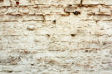 Texture of a brick wall with cracks and scratches which can be used as a background