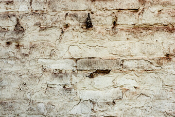 Texture of a brick wall with cracks and scratches which can be used as a background