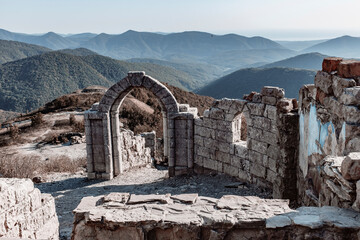 Old military dilapidated fortress on the background of a mountain pass in autumn. blurry focus