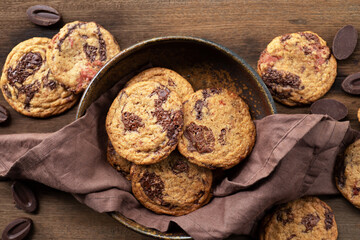 chocolate chocolate chip cookies on linen napkin on wooden table.
