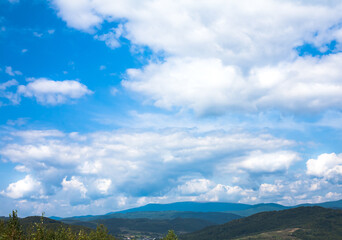 Summer landscape in mountains and the dark blue sky with clouds