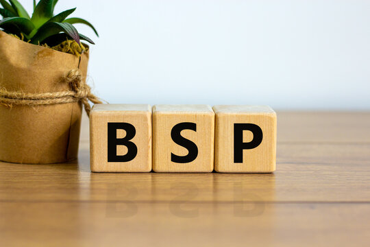 Concept word 'BSP - basic state pension' on cubes on a beautiful wooden table. White background. Business concept. Copy space.