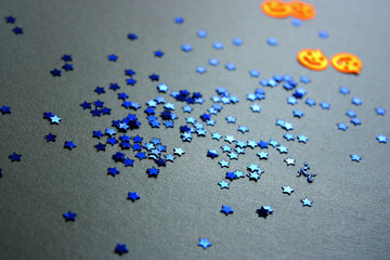 Deep blue sparkling stars with orange shiny pumpkins on silver background. Seamless pattern.