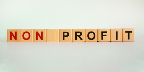 Concept words 'non profit' on wooden cubes on a beautiful white background. Business concept. Copy...